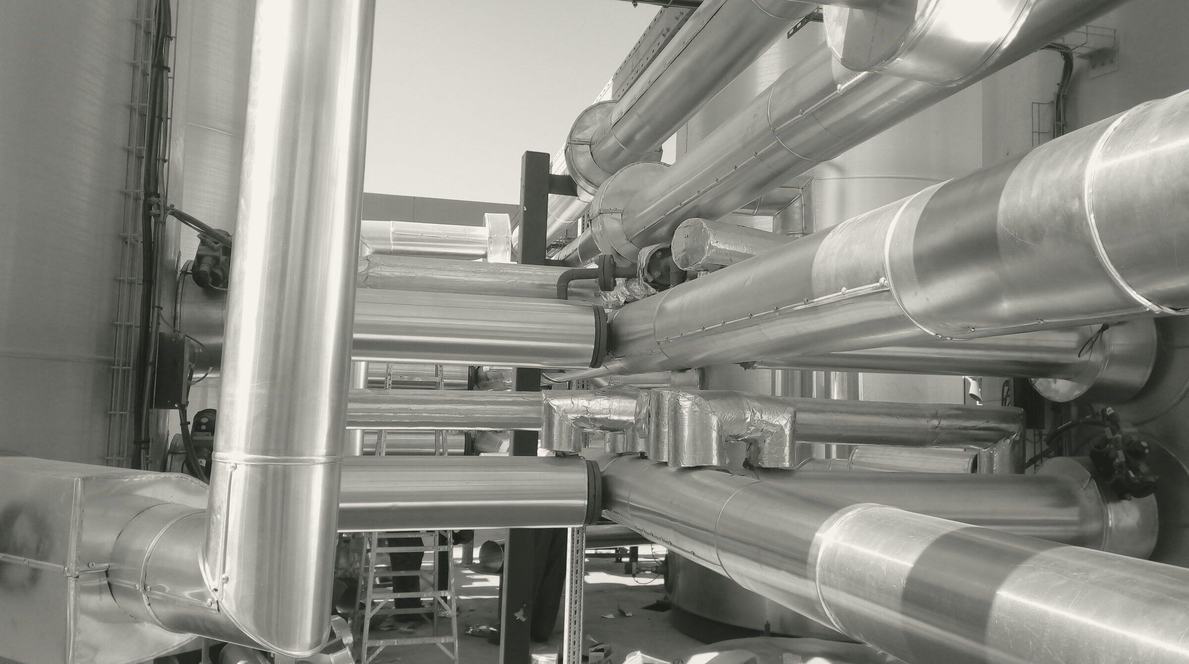 Cladded pipe runs between the storage tanks