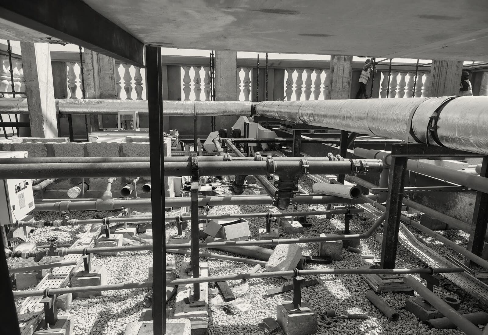 Chilled-water and drainage pipework set out across the roof