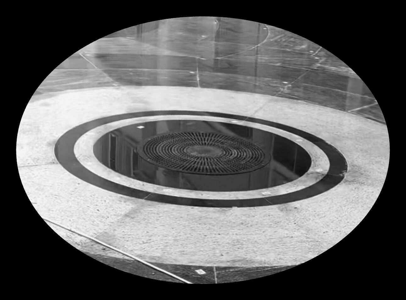 A circular floor grille finished flush in the stone